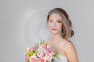 Asian bride standing and holding a bouquet