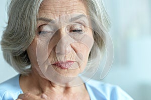 Close up portrait of a sick senior woman