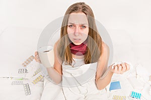 Close up portrait of sick woman with grippe holding cup of hot tea photo