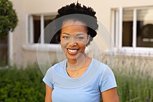 Close-up portrait of smiling african american young woman smiling while standing outdoors