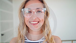 Close-up portrait of smiling businesswoman in eyeglasses at office