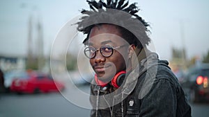 Close-up portrait of smiling handsome African American man in eyeglasses looking at camera. Cheerful young guy posing