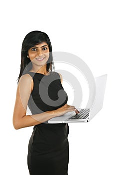 Close up portrait of a smiling Indian business woman working on a laptop