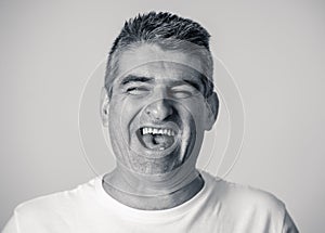 Close up portrait of a smiling and laughing mature man in happy face human emotions and expressions