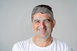 Close up portrait of a smiling and laughing mature man in happy face human emotions and expressions