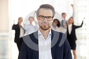 Close up portrait smiling millennial businessman in office.