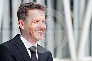 Close up portrait of smiling older businessman in suit and tie