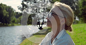 Close up portrait of smiling senior woman outdoors near river