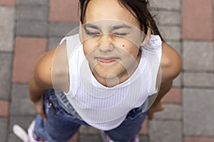 Close-up portrait of smiling teenage girl with closed eyes.