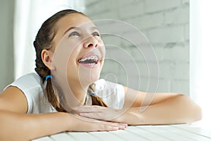 Close up portrait of smiling teenager girl showing dental braces.Isolated on white background.