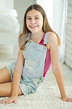 Close up portrait of smiling teenager girl showing dental braces. on white background.