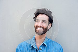 Close up portrait of a smiling young man in blue shirt