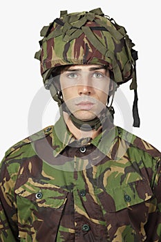 Close-up portrait of soldier against gray background
