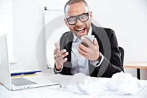 Close-up portrait of stressed businessman talking on mobile phone