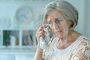 Close up portrait of stressed senior woman crying