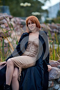 Close-up Portrait of Stylish Redhead Woman in Urban Autumn Fashion