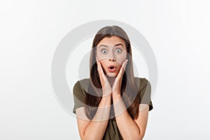 Close-up portrait of surprised beautiful girl holding her head in amazement and open-mouthed. Over white background