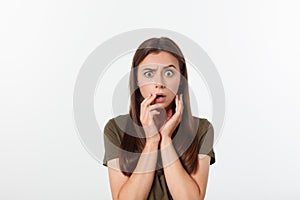 Close-up portrait of surprised beautiful girl holding her head in amazement and open-mouthed. Over white background