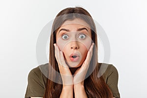 Close-up portrait of surprised beautiful girl holding her head in amazement and open-mouthed. Over white background