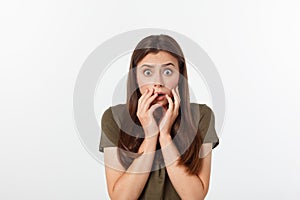 Close-up portrait of surprised beautiful girl holding her head in amazement and open-mouthed. Over white background