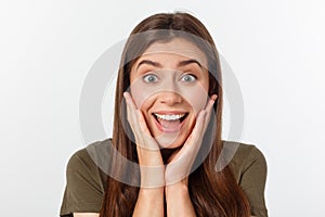 Close-up portrait of surprised beautiful girl holding her head in amazement and open-mouthed. Over white background