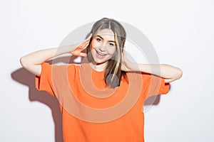 Close-up portrait of surprised beautiful girl holding her head in amazement and open-mouthed over white background