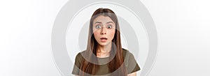 Close-up portrait of surprised beautiful girl holding her head in amazement and open-mouthed. Over white background