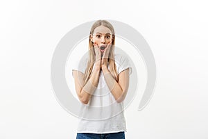 Close-up portrait of surprised beautiful young girl holding her head in amazement and open-mouthed. Isolated over white