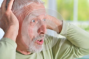 Close up portrait of surprised senior man