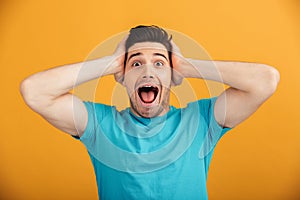 Close up portrait of a surprised young man in t-shirt