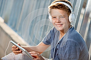 Close up portrait of teen boy with tablet.