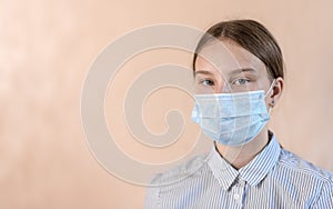 Close-up portrait, teenage girl in protective medical mask, free space copy text poster, stay home. Prevent coronavirus