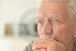 Close-up portrait of a thoughtful senior man