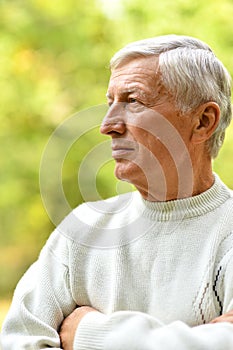 Close up portrait of thoughtful senior man outdoors