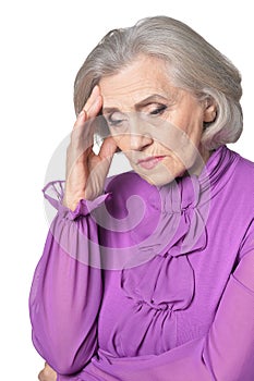 Close up portrait of thoughtful senior woman on white background