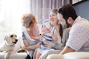 Close up portrait of three generations of women being close, grandmother, mother and baby daughter at home