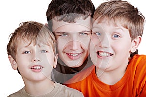Close-up portrait of three grinning boys