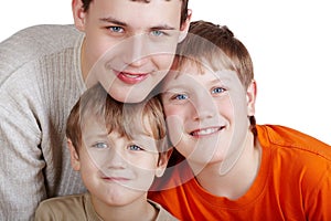 Close-up portrait of three smiling boys