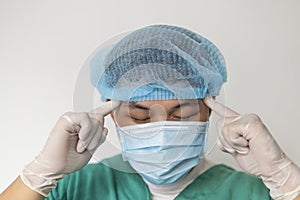 Close up portrait of Tired doctor at the hospital. A doctor, a nurse who is thinking about treating a disease and a pandemic.