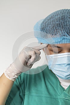 Close up portrait of Tired doctor at the hospital. A doctor, a nurse who is thinking about treating a disease and a pandemic.