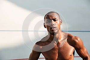 Close-up portrait of a tired handsome african sports man, resting after workout