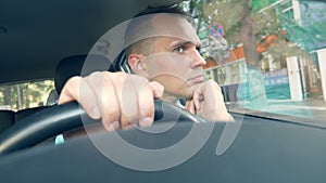 Close up. portrait of a tired man driving a car in a traffic jam
