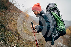 Close up portrait of traveler bearded man trekking and mountaineering during his journey.