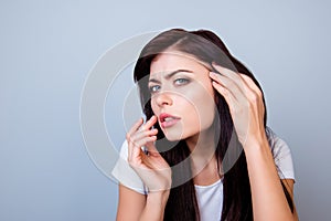 Close up portrait of troubled young girl touching lips looking a