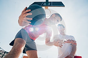 Close up portrait of two basketball players while the push each other for ball possession