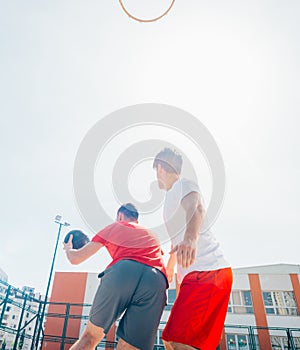 Close up portrait of two basketball players while the push each other for ball possession