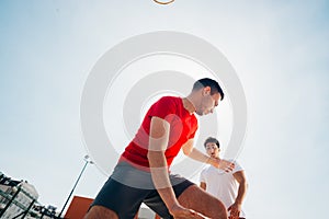 Close up portrait of two basketball players while the push each other for ball possession