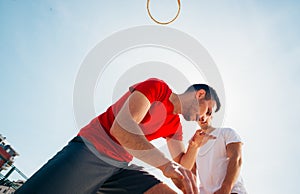 Close up portrait of two basketball players while the push each other for ball possession