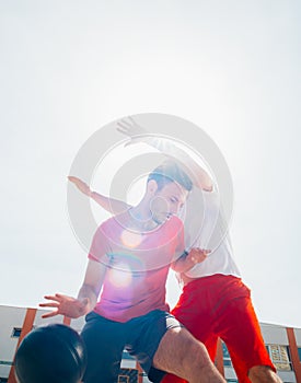 Close up portrait of two basketball players while the push each other for ball possession