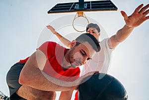 Close up portrait of two basketball players while the push each other for ball possession